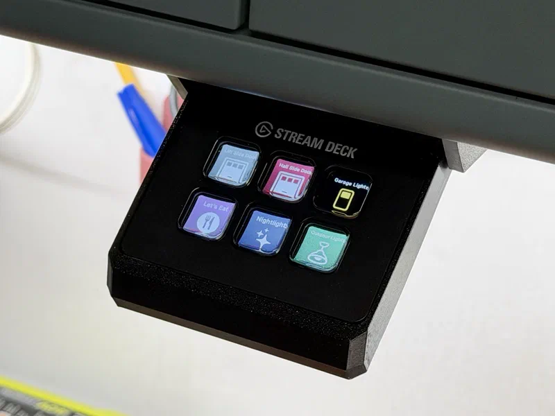 A Stream Deck Mini mounted under a shelf, showing six HomeKit keys.